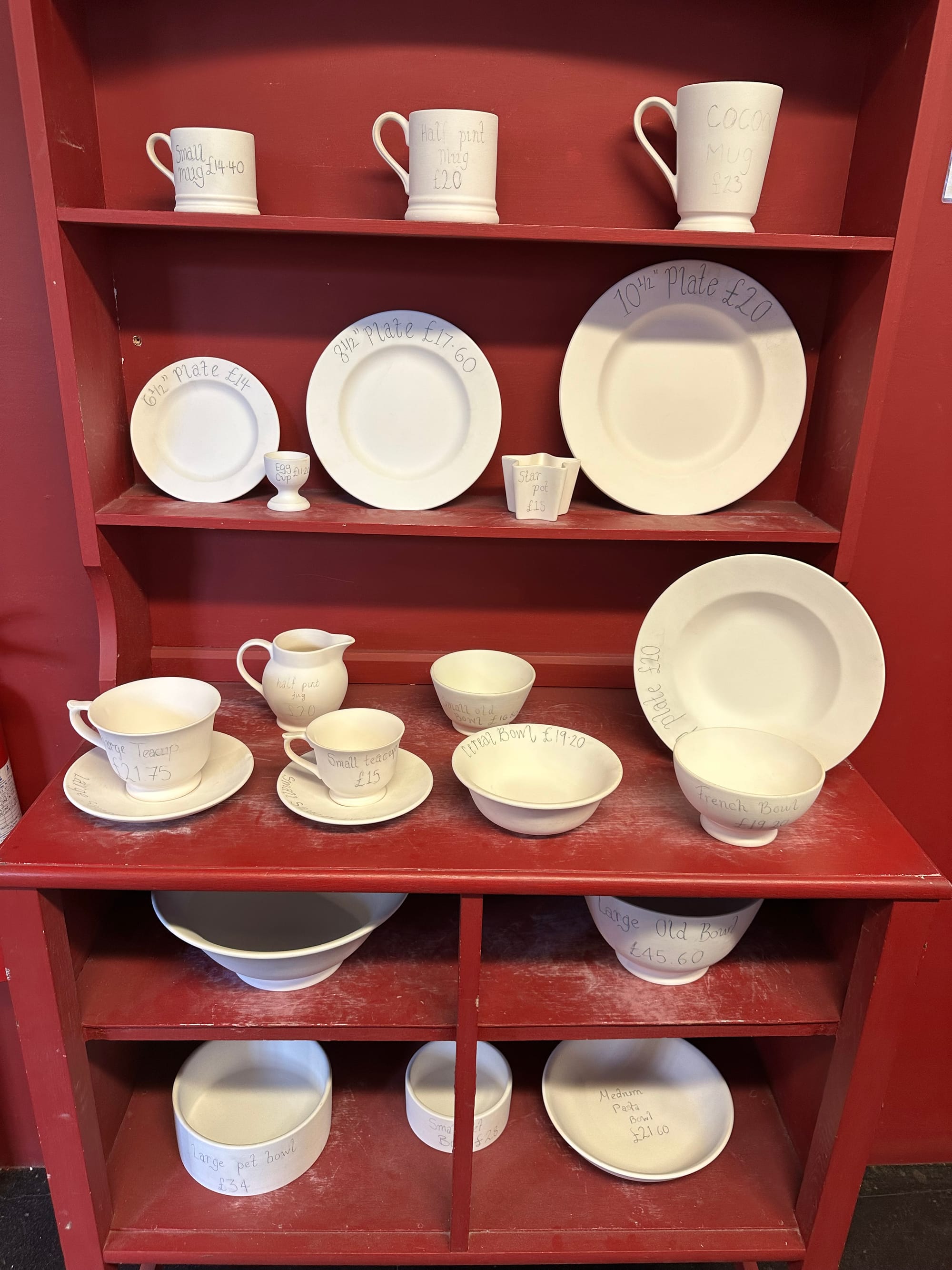 A dresser with various items on it that you can choose from, with the price of each item written on it