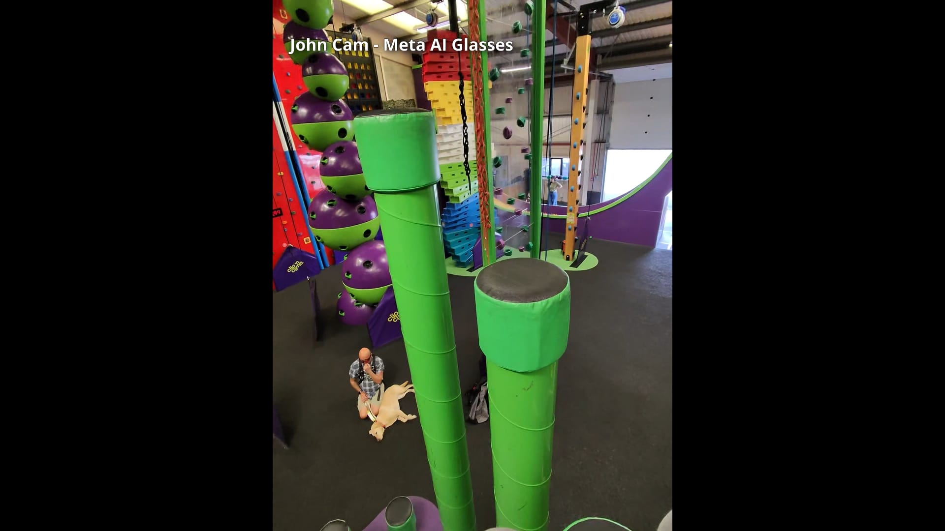 A still image from John's POV footage from his glasses. He is on a pole near to the top of the "Stairway to Heaven". In front of him are other walls that can be climbed, and on the floor below Wayne and Liberty can be seen waiting.