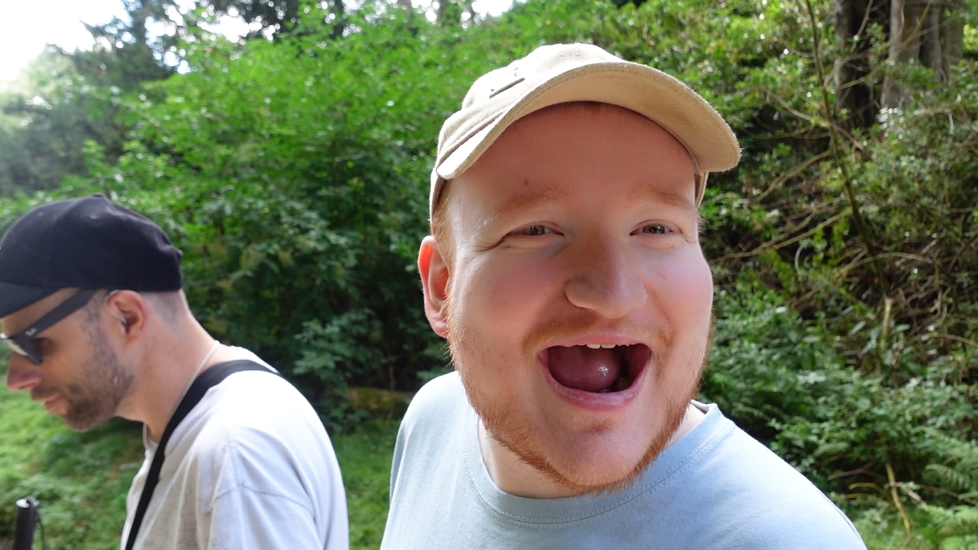 A picture of George looking at the camera with his mouth open in a smile