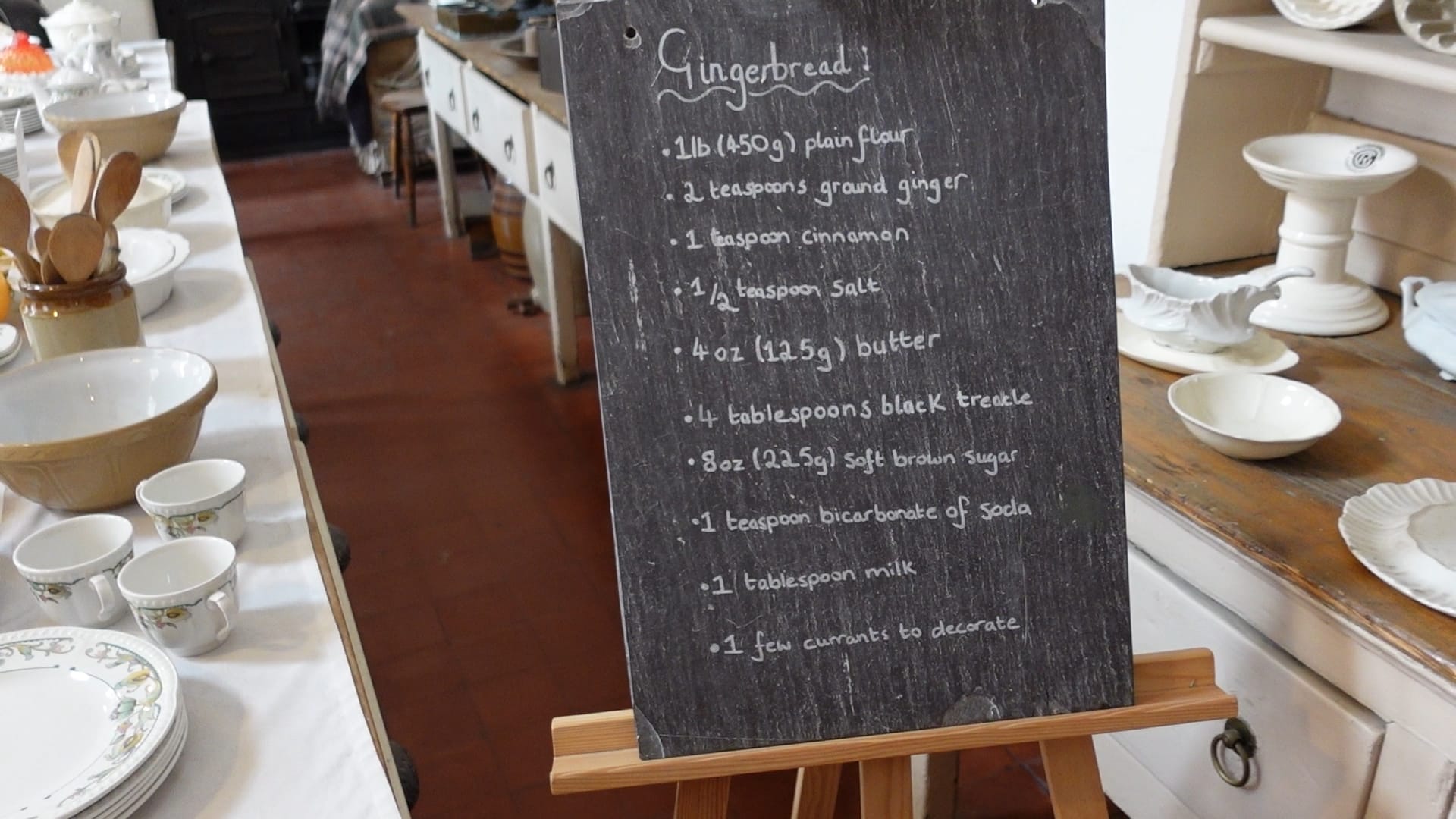 A chalkboard on an easel listing the ingredients for making gingerbread