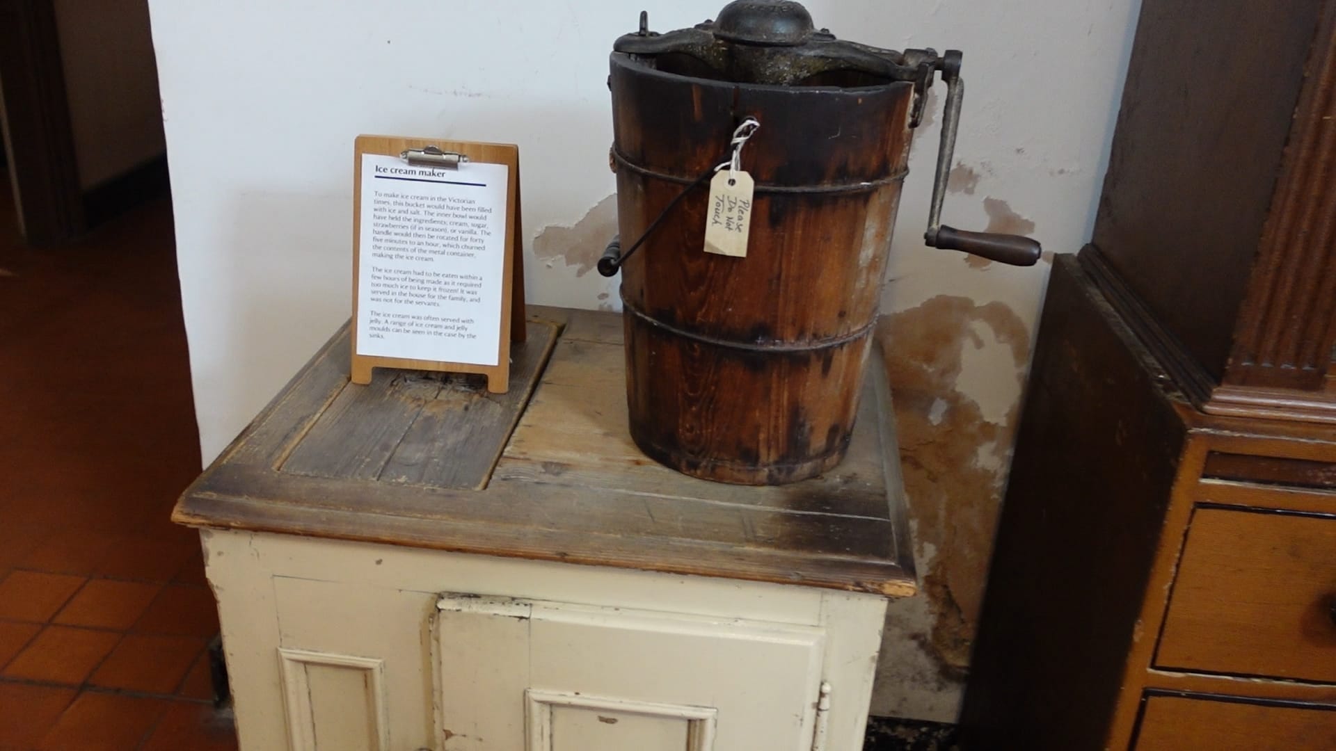 A large wooden bucket with a handle on its right. To the left is some information about how the ice cream was made