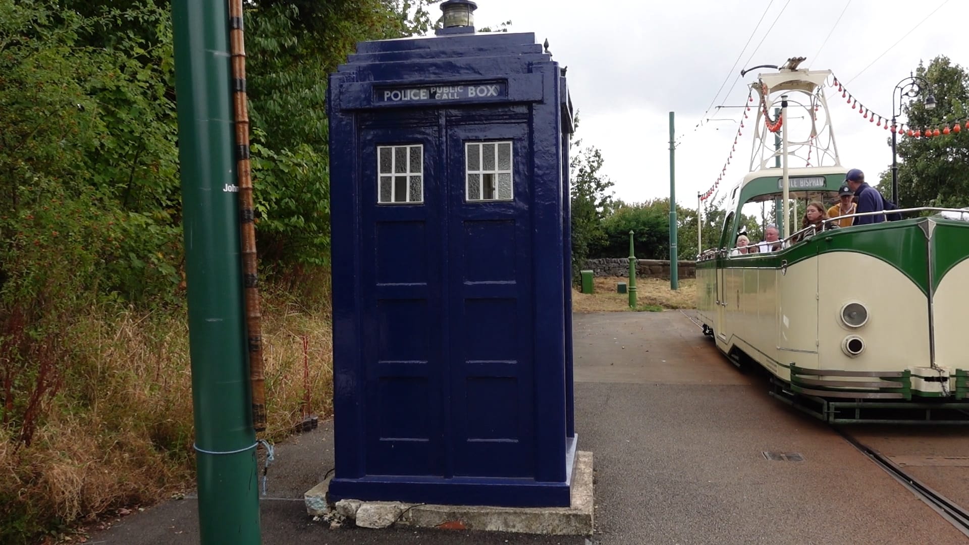 A blue police box. It has a light on the top and a sign says Police Box, with the words Public Call between the words police and box.