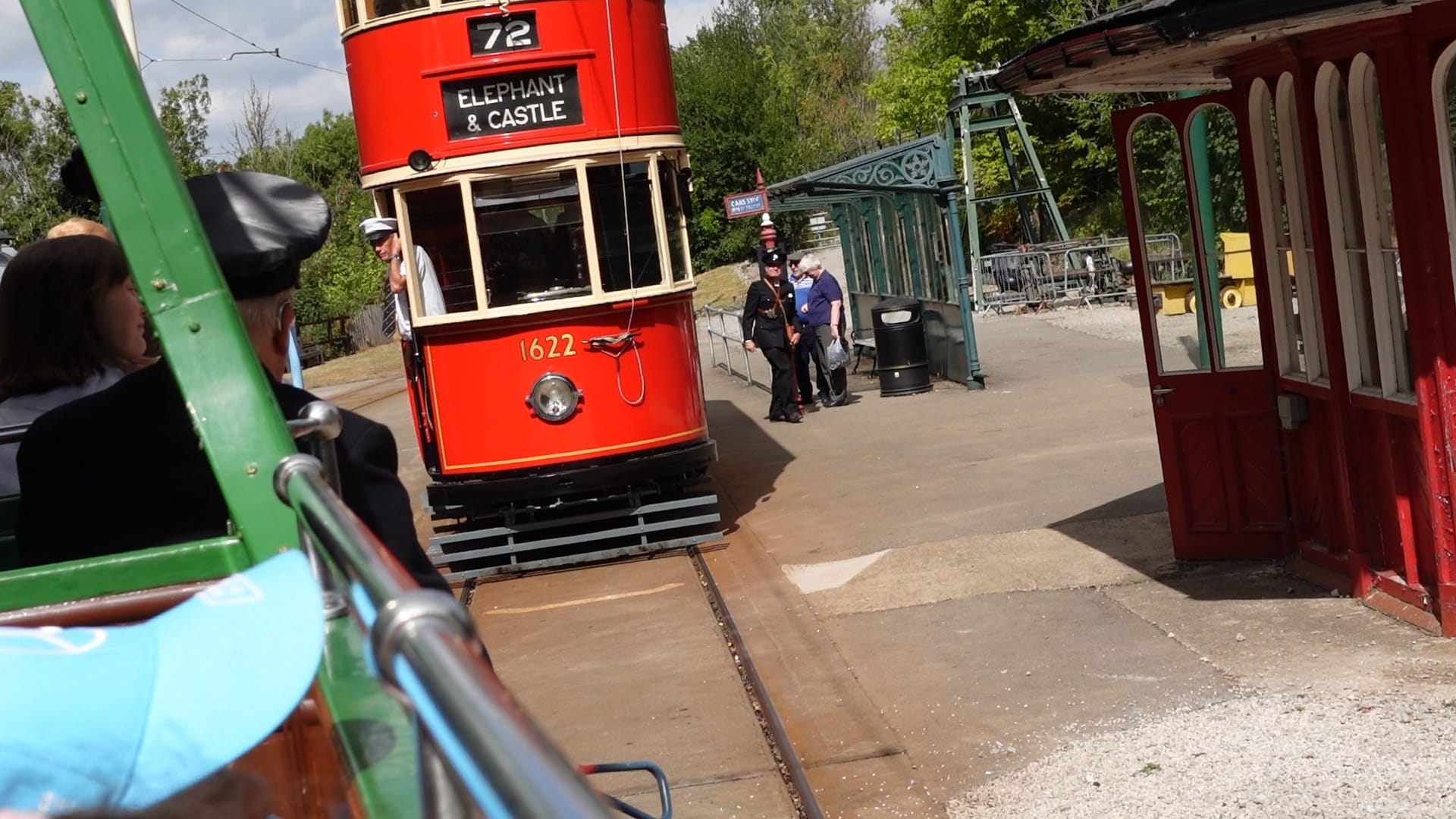 A view from the tram we were riding on. In front, slightly to the right, is a double decker tram painted in red. It has the route number as 72 and the destination as Elephant & Castle. It has a single headlight below the driver's window and above the headlight the number 1622 is painted on in gold paint.