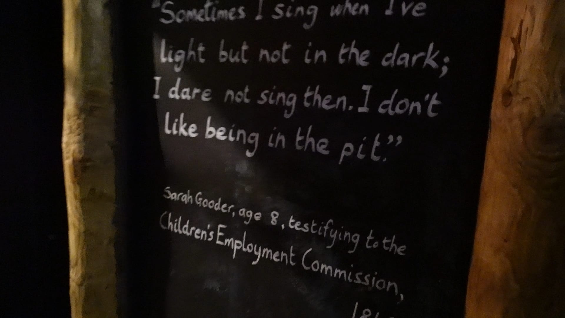 A black board showing Sarah Gooder's words. It says "Sometimes I sing when I've light but not in the dark; I dare not sing then. I don't like being in the pit."
