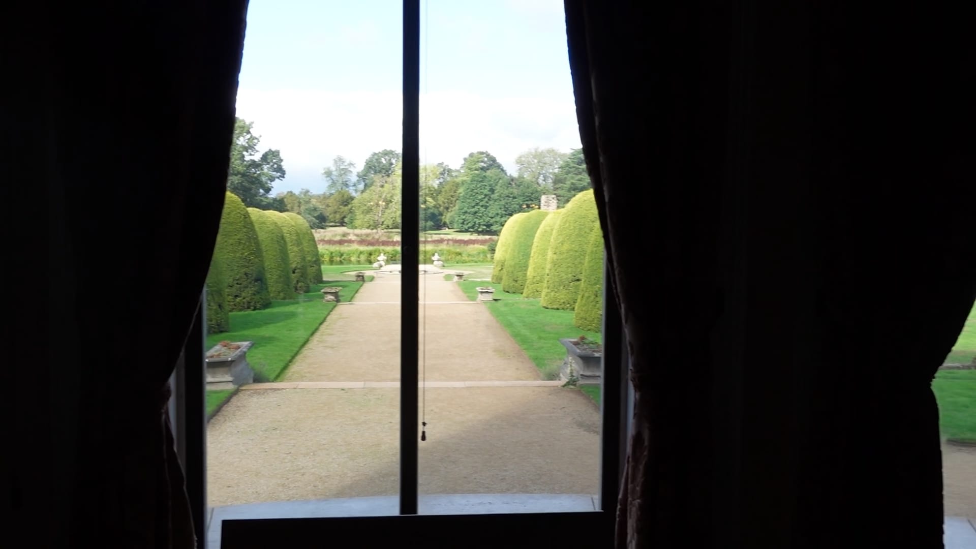 A view out of a window, down the path towards the lake.