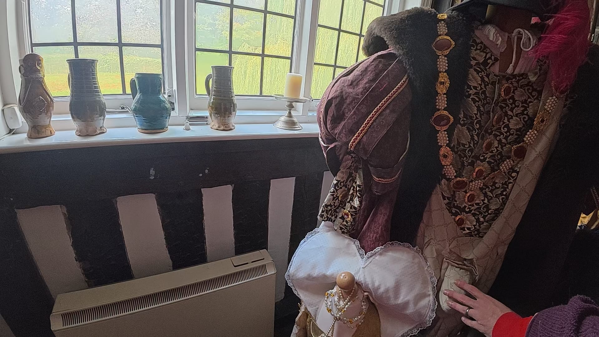 John is touching the elaborate period costume. In this photo, he has found the codpiece!
