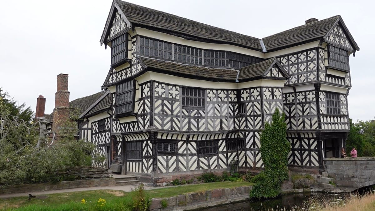 A close up picture of the outside of Little Moreton Hall, showing how the walls and floors sag