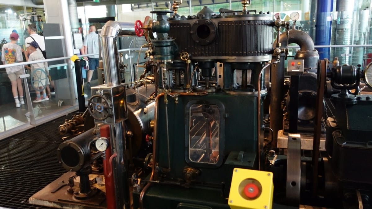 A large machine with many dials and pipes on it, that produces electricity