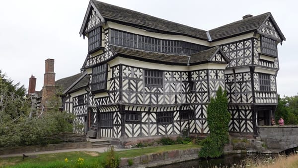 A close up picture of the outside of Little Moreton Hall, showing how the walls and floors sag