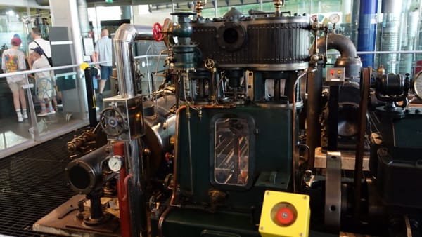 A large machine with many dials and pipes on it, that produces electricity